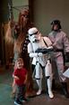 A little boy poses with cosplayers in "Star Wars" character costumes during LibraryCon 2016. 