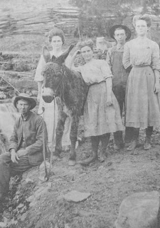 Clayton Stokley, Lottie, Addie, Edward, and Bernice. (The burro's name has been forgotten). Judge Stokley and his family were customers at the old Pedrow trading center, and the Judge declared that William Moberly made the best buckwheat flour in the country.
