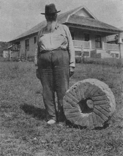 Mr. John B. Cloud and the stone burr from the Reynolds Mill.