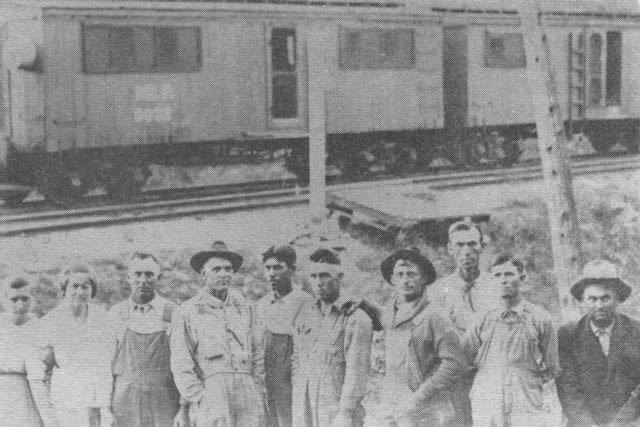 Boarding cars on Melva siding. Emma Oliver and Florence Box at left. 4th from left, Walter Robertson. His snapshots of the children of Mr. and Mrs. William Box were the only ones they had. 5th from left, Ranzy Box, and 7th from left, Wilson Bell. Others are unidentified.