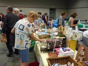 A woman browses the sales tables at the Between Friends Gift Shop Sidewalk Sale.