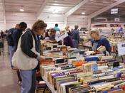 Shoppers browse tables full of books at the Friends of the Library Book Sale.