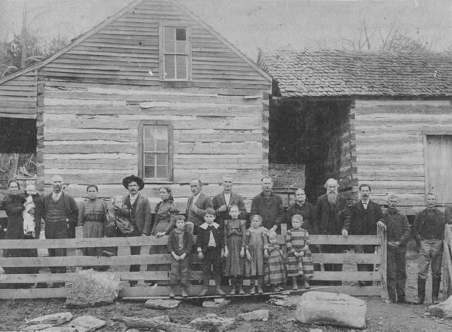 The William and Missouri Casey homestead about 1900. L to R: Tisha Casey holding Roy, Ben Casey, Cora, Jim Hicks holding Mabel, Bertie, Button, Calvin, Jeff, Aunt Sis and Uncle Ben McKinney, Dock, Price, Lonnie, Missouri, and Mandy holding Edna. The children in front are Mack, Ralph, Alpha, Bertha, Manferd, and Claudia. The house, built before the Civil War, is still standing.