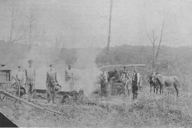 SORGHUM MAKING about the turn of the century. Scenes like this one, photographed about 60 years ago on the farm now owned by Ellis Blevins, were once familiar sights in the Ozarks. At left are three brothers, Dan, James M., and Ruel Mayes. One of the other men is Will Mayes, an uncle.