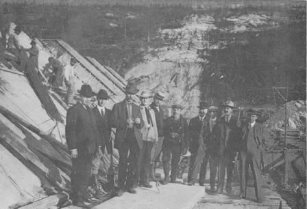 Second from left: T. C. Kennedy, secretary of the White River Construction Co, and purchasing agent; 4th from left: Russell T. Bailey, resident engineer; 5th from left: W. E. Maxon, superintendent of construction for Ambursen Hydraulic Construction Co.