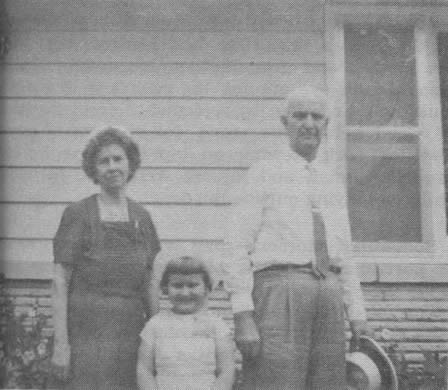 Percy Bridges, his wife May, and their granddaughter Peggy Jean Melton, 5, standing before the Bridges' new retirement home in Ozark, Mo. Mr. Bridges retired in 1962 after 35 years as a teacher in the rural schools of Christian County, Missouri.